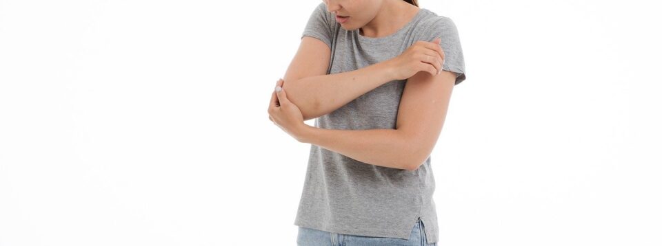 Woman suffering from elbow joint pain